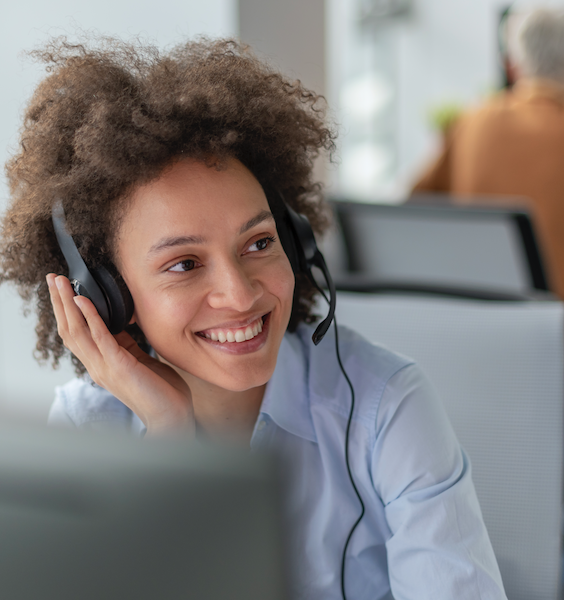 A woman at a BI Incorporated call center, actively participating in a call, showcasing her professionalism and dedication.